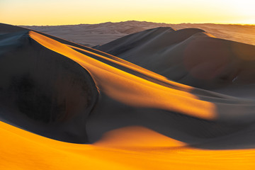 Sunset in the sand dunes and desert between Ica and Huacachina, Peru, South America.