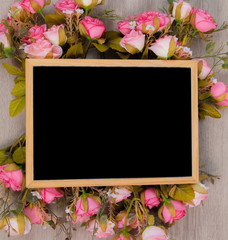 Top view flat lay wedding background concept with chalkboard mock up frame and beautiful pink rose bouquet flowers decorations on white background