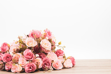 Selective focus Beautiful pink rose bouquet composition on wooden table for wedding or anniversary concept with copy space
