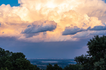 Storm clouds over holm oaks fields