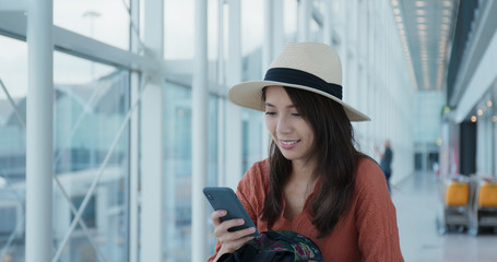 Woman use of mobile phone in the airport