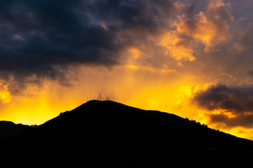 One of the peaks of the active Pichincha volcano seen from the city of Quito at sunset with beautiful colors, Ecuador, South America.