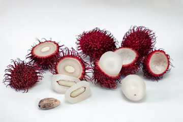 Tropical exotic rambutan fruit, whole, half, cut, seed, flesh isolated on white background