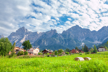 Obraz premium green village at the foot of the mountain