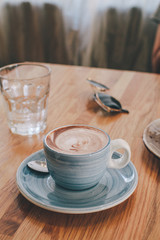Blue Cups of hot Chocolate drink on dark wooden background. Morning time. Holiday concept, Selective focus
