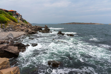 Obraz premium The rocky coast of the Black Sea near the ancient city of Sozopol. Bulgaria. In the background are the islands of St. Peter and St. Ivan.