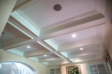 Coffered ceiling and a lot of natural light from the large windows.