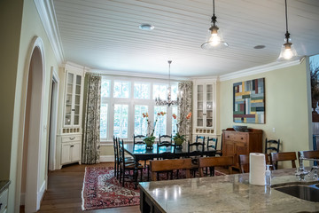 spacious dining room eat in kitchen full of windows and natural light table and chairs  and white shiplap ceiling
