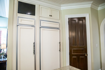  kitchen with hardwood floors and custom cabinets and panel covered hidden refrigerator