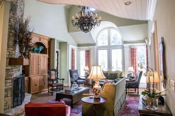 Stylish and rustic cabin lodge living room den area with pine built-in, chandelier and view of the upstairs