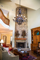 Stylish and rustic cabin lodge living room den area with pine built-in, chandelier and view of the upstairs