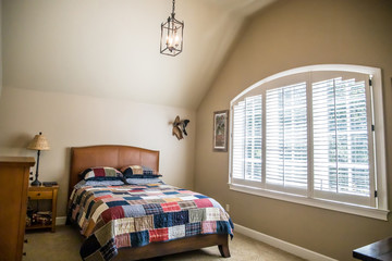 Teen traditional boy bedroom in a suburban home house with plaid comforter