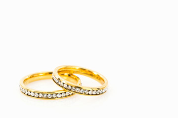 Gold wedding rings on white background