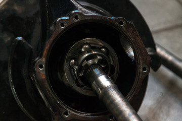 Close-up on a wheel joint from a car with a differential during repair, a used spare part. Auto service industry.