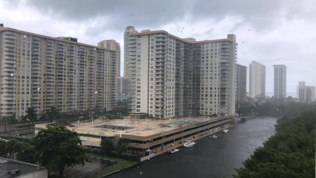 Rainy Weather, Rain Drops, Modern Buildings And Channel View On A Background. Heavy Rain In The City Before Hurricane Dorian. Miami, USA