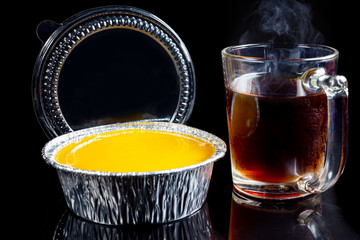 Orange cake, Hot coffee on a black background.