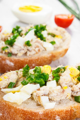 Closeup of baguette with fresh mackerel or tuna fish paste, healthy nutrition concept