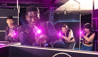Fototapeta na wymiar African American man playing lasertag