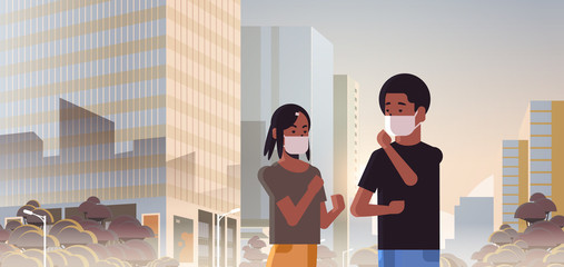 couple wearing face masks toxic gas air pollution industry smog polluted environment concept man woman walking outdoor dirty smoke skyscrapers cityscape skyline background portrait horizontal