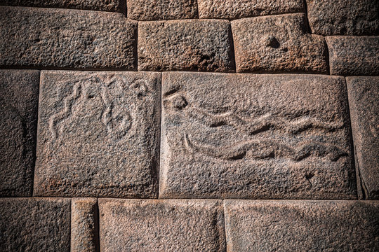 Inca stones, with carved snake at wall of mythical street from Cusco, Peru, called seven snakes.