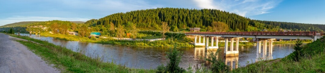 Road bridge over the river Usva in the village of Usva. Gremyachinsky district, Perm Krai, Russia. Panorama.