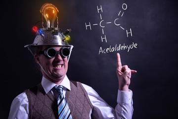 Nerd presenting handdrawn chemical formula of acetaldehyde