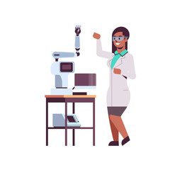 female scientist near industrial robotic arm african american woman in uniform with robot manipulator smart medical machine automatic technology concept full length flat © mast3r