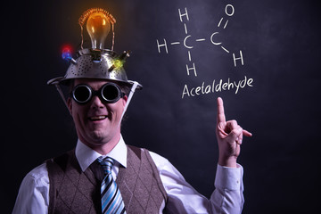 Nerd presenting handdrawn chemical formula of acetaldehyde