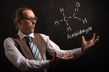 Professor presenting handdrawn chemical formula of acetaldehyde