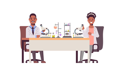 scientists couple using microscope african american man woman in uniform sitting at table making scientific experiments in chemistry laboratory with test tubes research science concept full length
