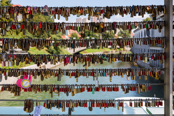Love padlocks on the fence of the bridge over the river in Ljubljana