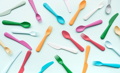 Top view of colorful spoon and fork element on color table.flat lay