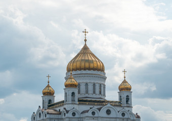 Fototapeta na wymiar golden domes of the church with crosses against the sky