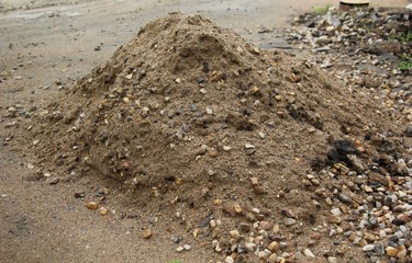 pile of construction sand with stones