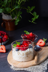 delicious milk rice with different berries and red fruit jelly