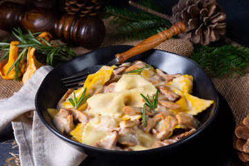 Colorful farfalle pasta with chanterelles and cream sauce.