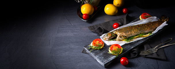 baked trout with herb filling and tomatoes