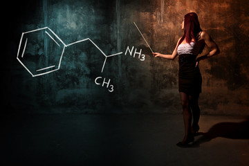Sexy girl or secretary or female student presenting handdrawn chemical formula of amphetamine