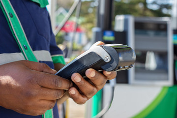african american man holding a bank card machine