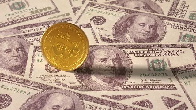BitCoin Crypto currency spinning on One hundred Dollar bills background in slow motion.
