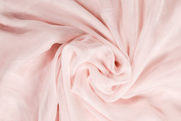 Fototapeta na wymiar Soft smooth pink silk fabric background. Fabric texture.