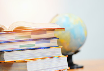 Education concept back to school and business study global world - open book in library with book stacked and earth globe model map