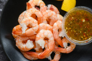fresh shrimps served on plate with seafood sauce - boiled peeled shrimp prawns cooked in the restaurant