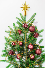 Fototapeta na wymiar Christmas tree with balls made of branches on a white background.