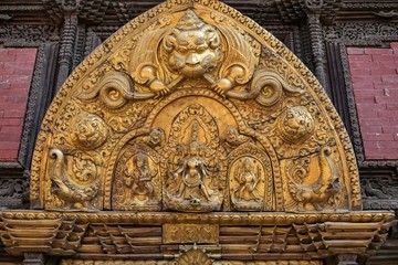 Fototapeta na wymiar Various embodiment of Hindu Gods carved on a metal plate in Patan Durbar Square.