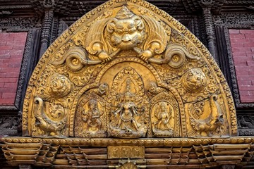 Various embodiment of Hindu Gods carved on a metal plate in Patan Durbar Square.