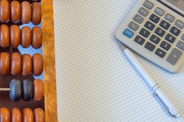 Vintage abacus, sheets of paper, calculator.  Copy space