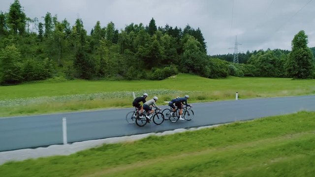 Team of cyclists ride in beautiful scenery