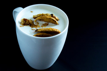 .white mug with yogurt and biscuits isolated