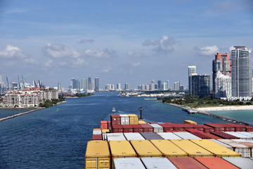 Large cargo container ship entering port of Miami. View from the navigation bridge. - obrazy, fototapety, plakaty